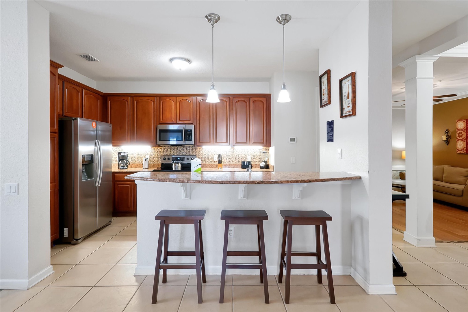 Your fully equipped kitchen features granite counters, stainless appliances, and a breakfast bar perfect for morning coffee or casual dining.