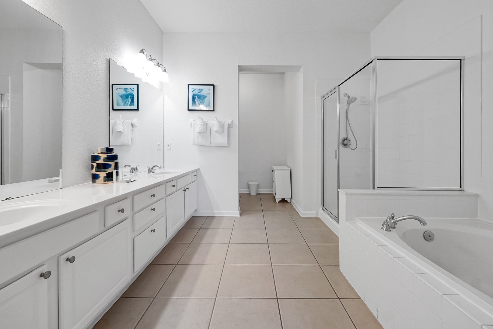 Step into a bright, spacious bathroom designed for your comfort. With a soaking tub, walk-in shower, and dual vanities, there's plenty of room to relax and refresh after your day of adventure.