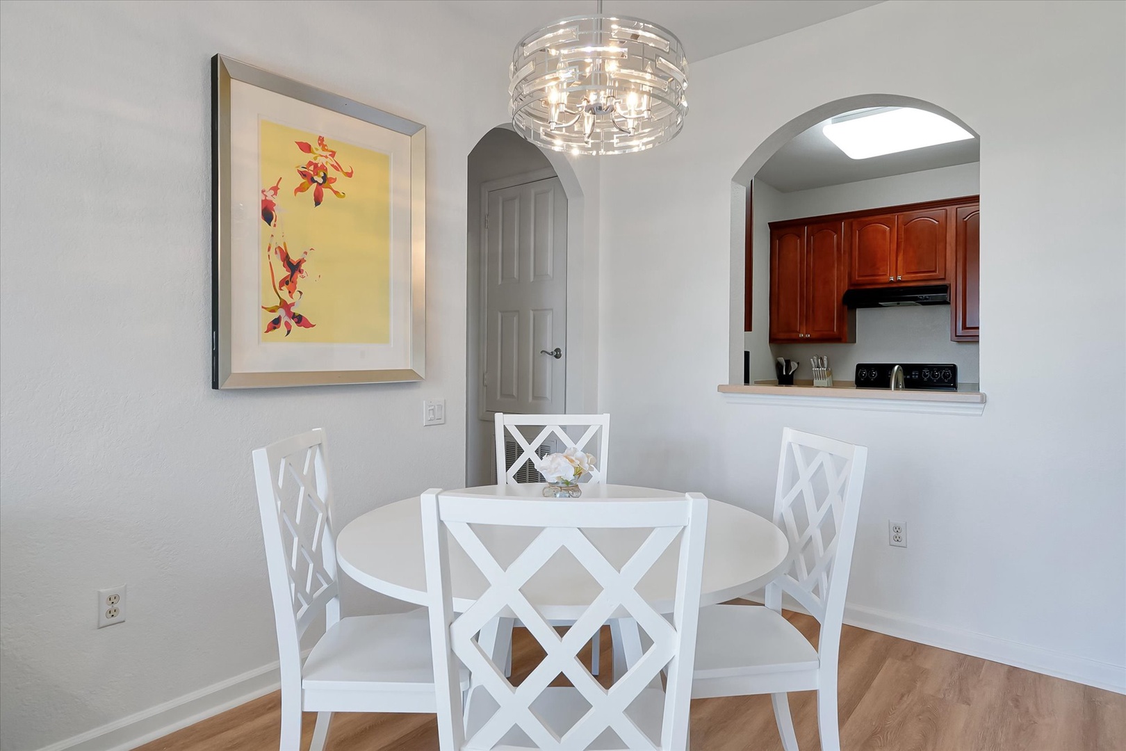 Gather around your elegant dining table for memorable meals, illuminated by a stunning chandelier with your fully equipped kitchen just steps away.