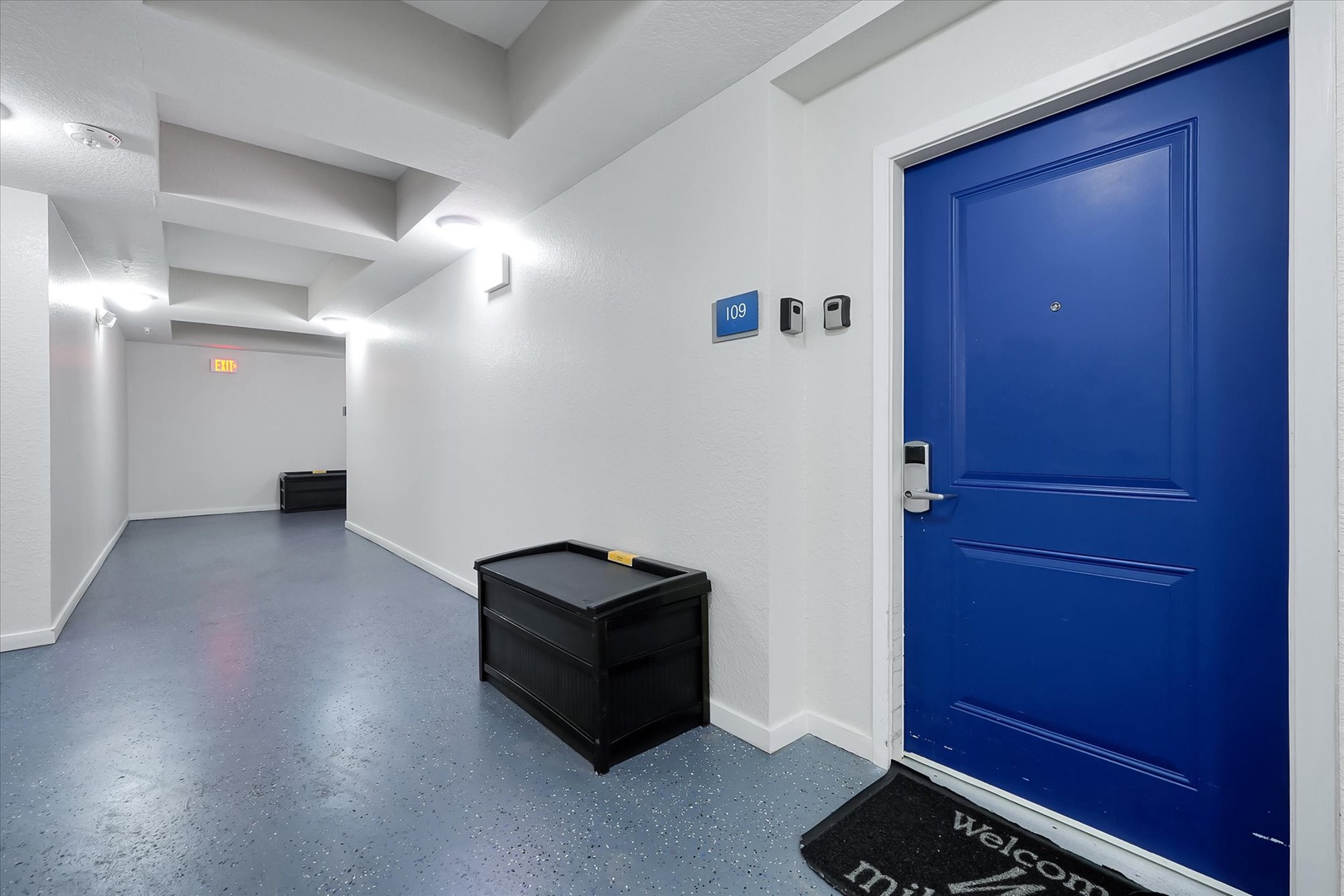Welcome to your secure apartment entrance with convenient storage benches and modern hallway design for a comfortable arrival experience.