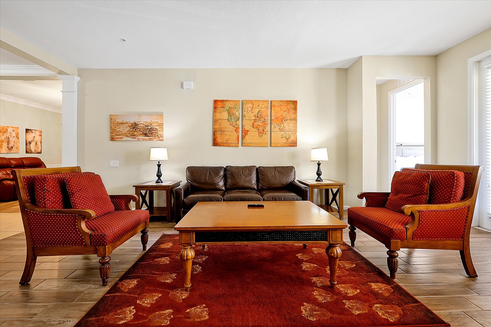 Unwind in your elegant living space featuring plush seating, vintage maps, and warm lighting that creates the perfect atmosphere for relaxation.