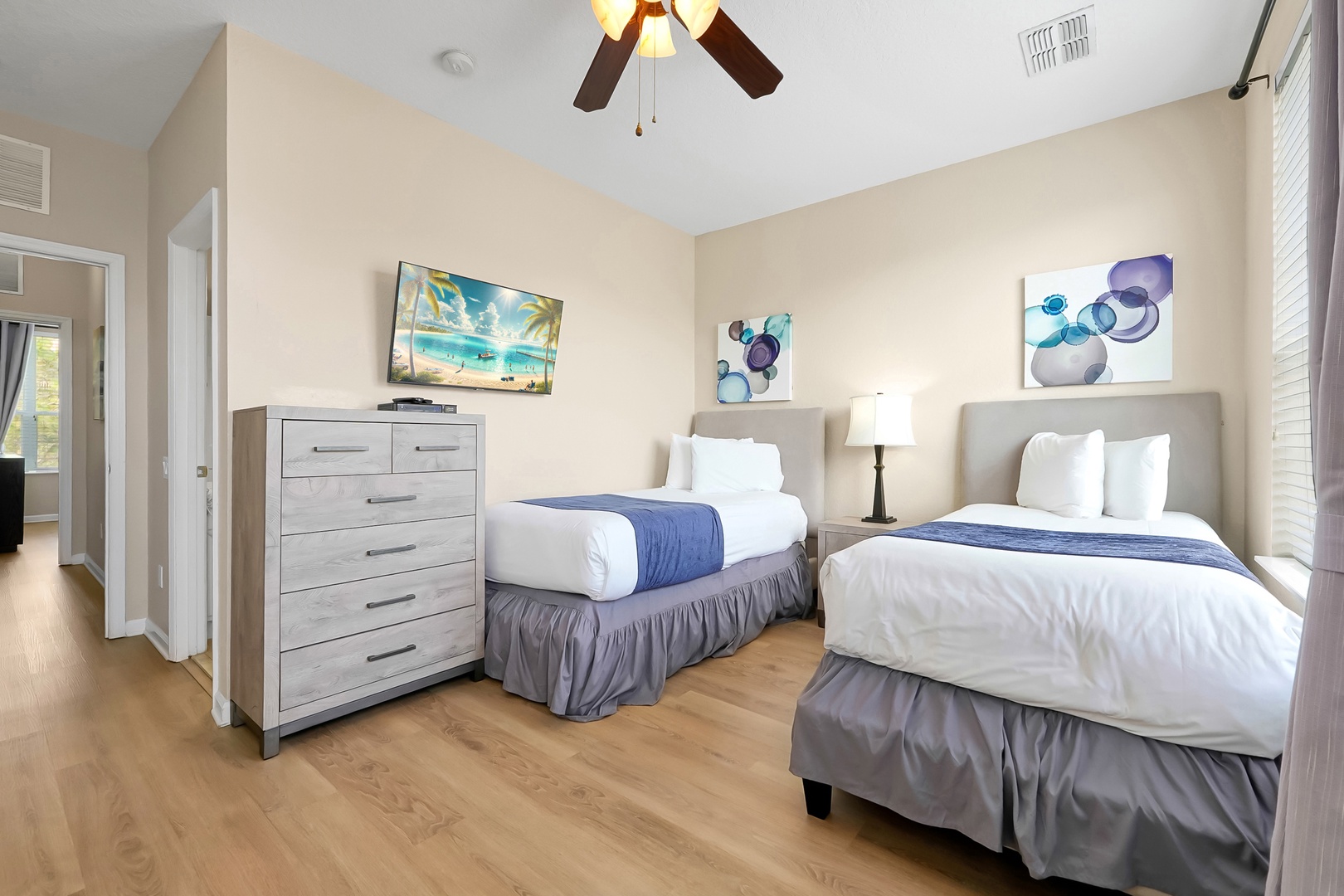 Your stylish twin bedroom features two comfortable beds with crisp linens and coastal artwork to inspire peaceful dreams.