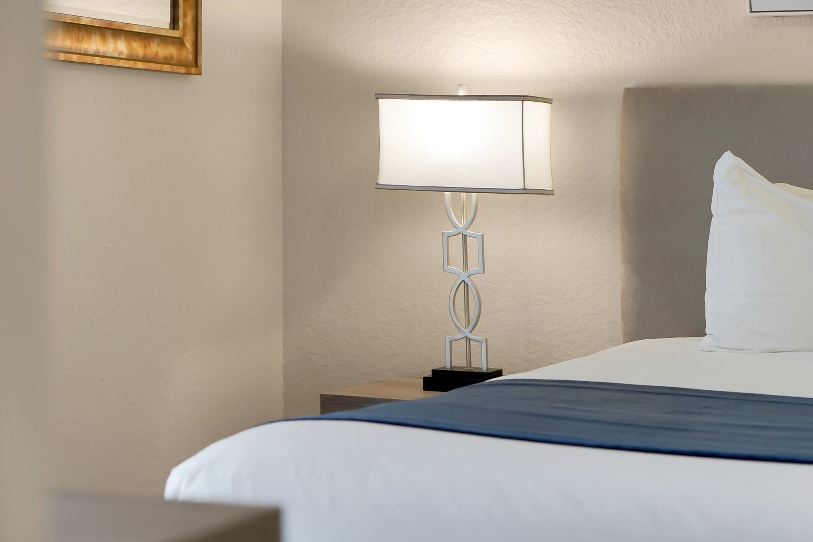 Sink into crisp white linens and enjoy the soft glow of your bedside lamp after a day of exploring.