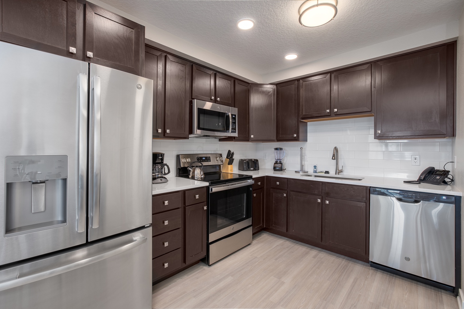 Your fully equipped kitchen features modern stainless steel appliances and rich wood cabinets, perfect for preparing home-cooked meals during your stay.