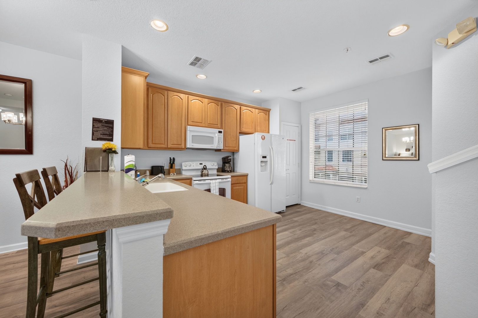 Step into your fully equipped kitchen, complete with modern appliances, ample counter space, and a convenient breakfast bar—perfect for whipping up meals and sharing stories over morning coffee.