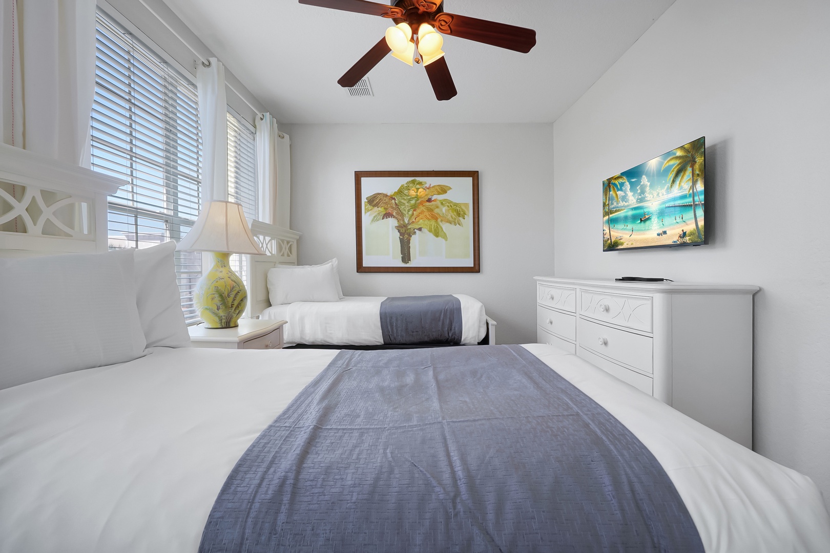 Rest peacefully in your twin bedroom, featuring tropical decor and gentle ceiling fan for perfect comfort.