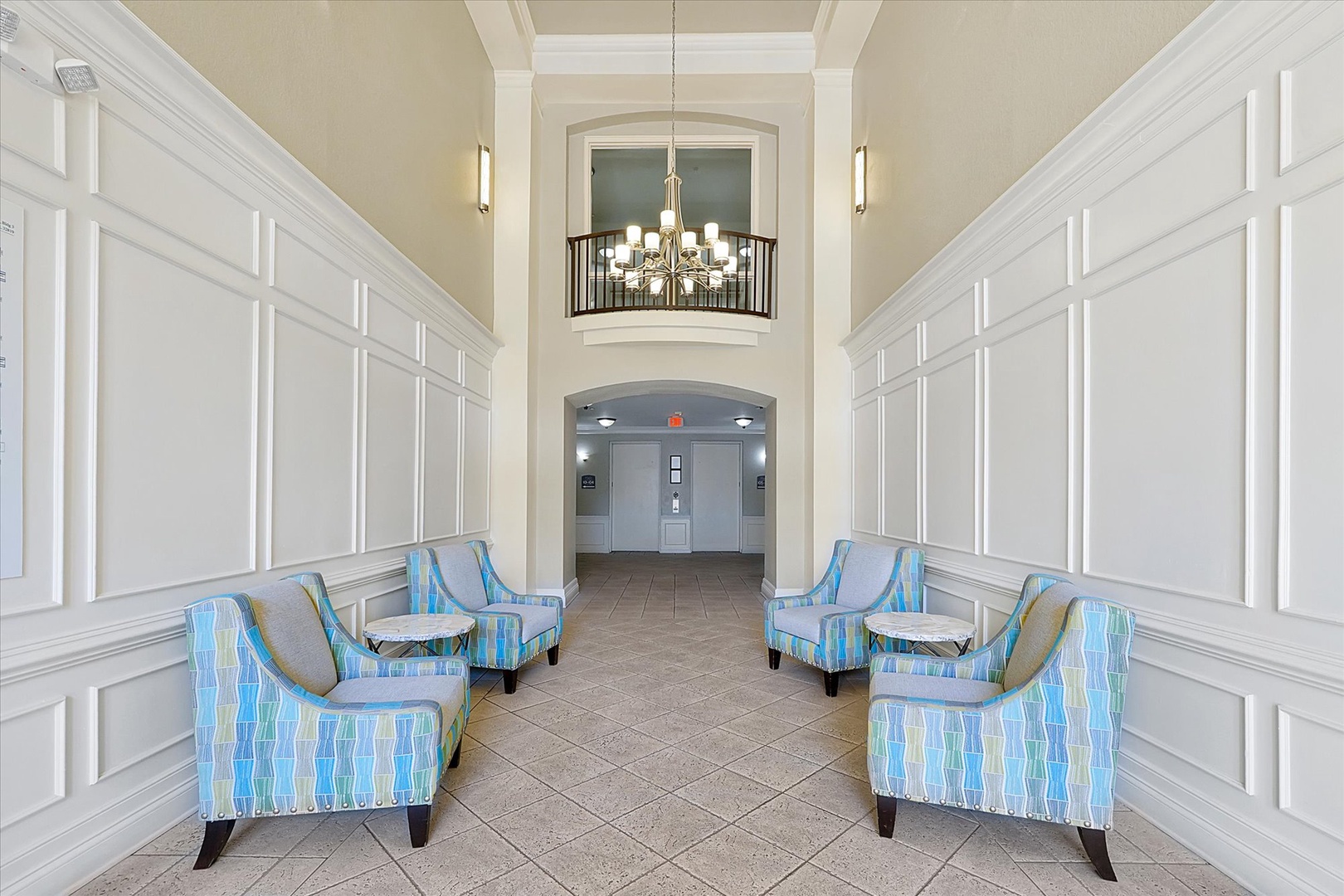 Elegant lobby with stylish seating awaits your arrival, featuring sophisticated decor and comfortable chairs for relaxing.