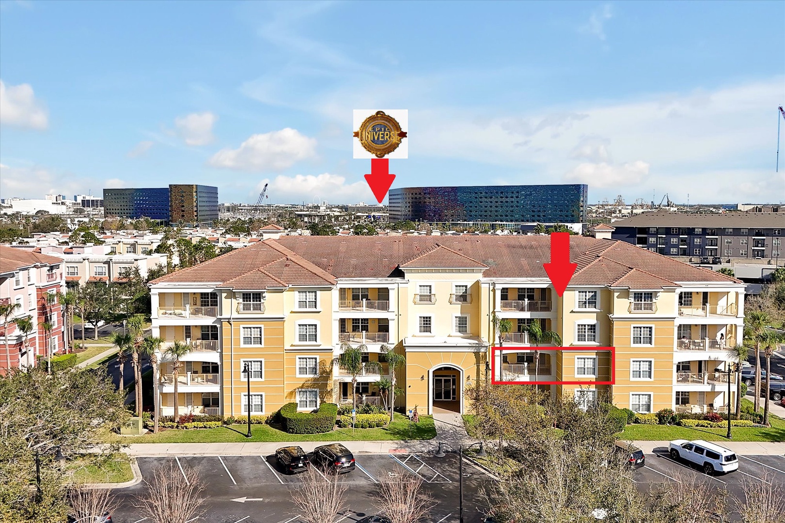 Aerial view of a charming resort community with Spanish-style architecture and landscaped grounds in a vibrant neighborhood setting.