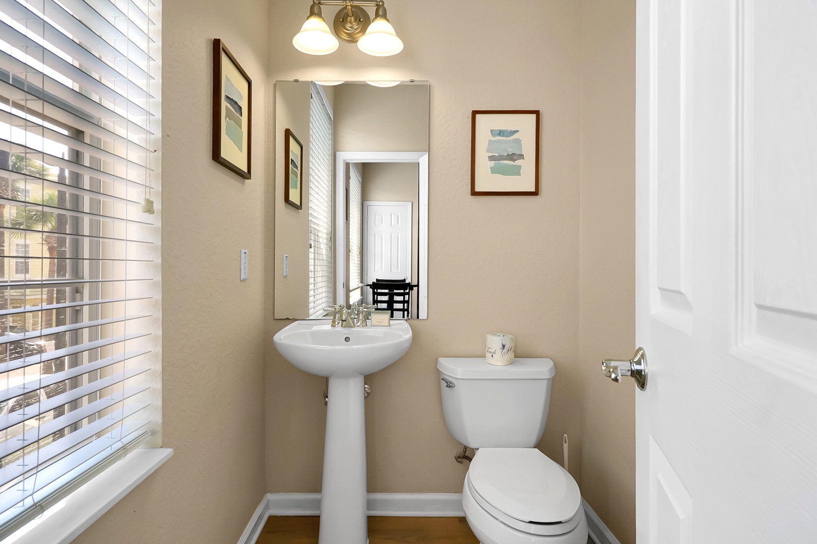 Half bathroom/powder room located right off the kitchen area for your convenience.