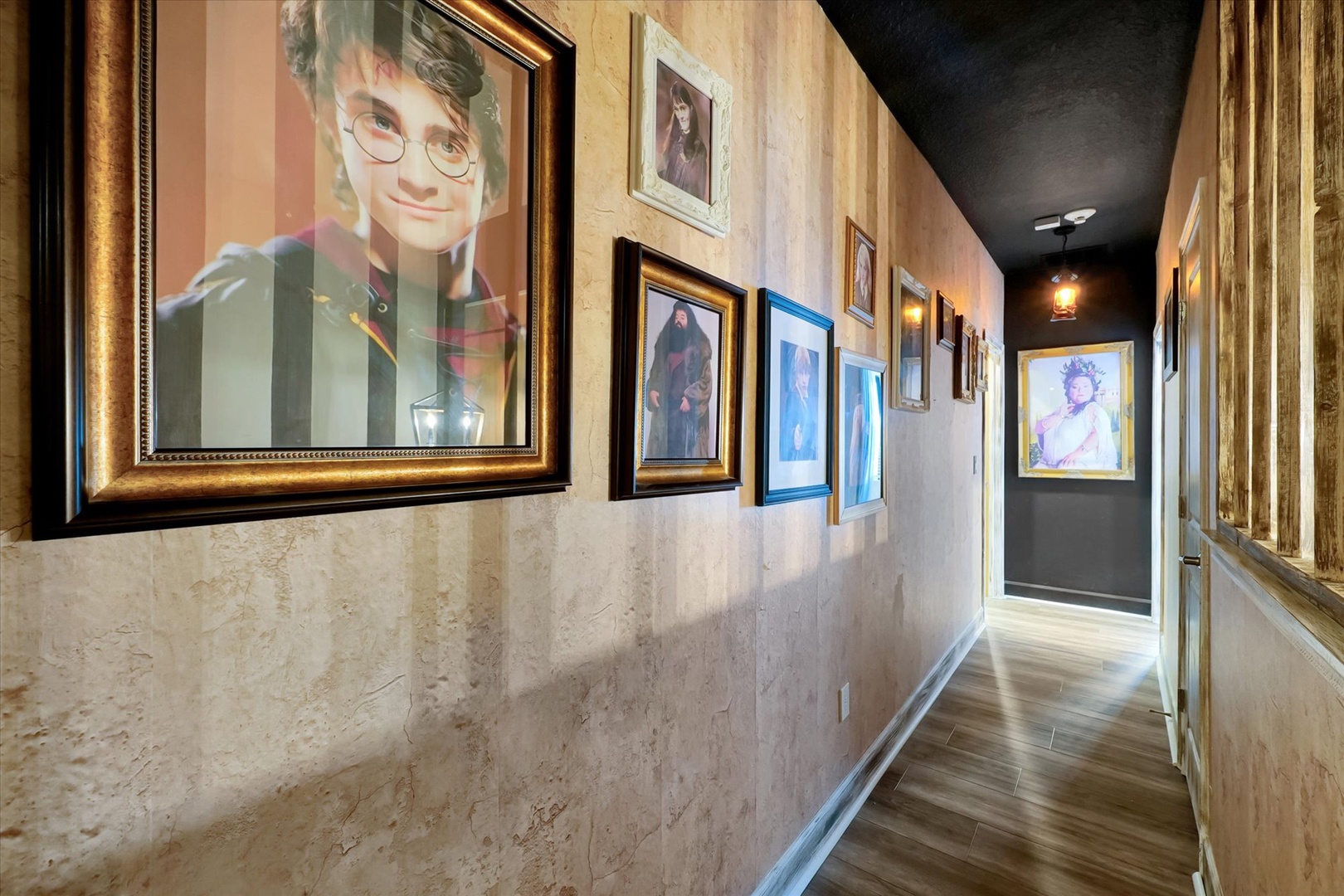 A magical hallway adorned with enchanting portraits that bring a touch of fantasy to your stay. Notice the warm wood floors and elegant frames creating a whimsical, storybook atmosphere.