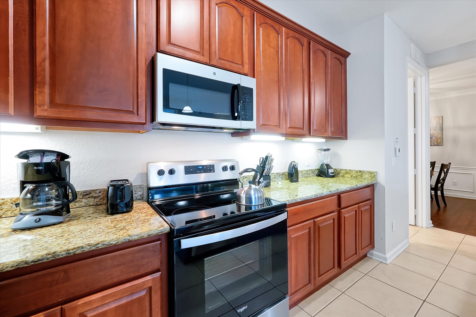 Your fully equipped kitchen features warm cherry cabinets, granite countertops, and stainless steel appliances for home-cooked meals.