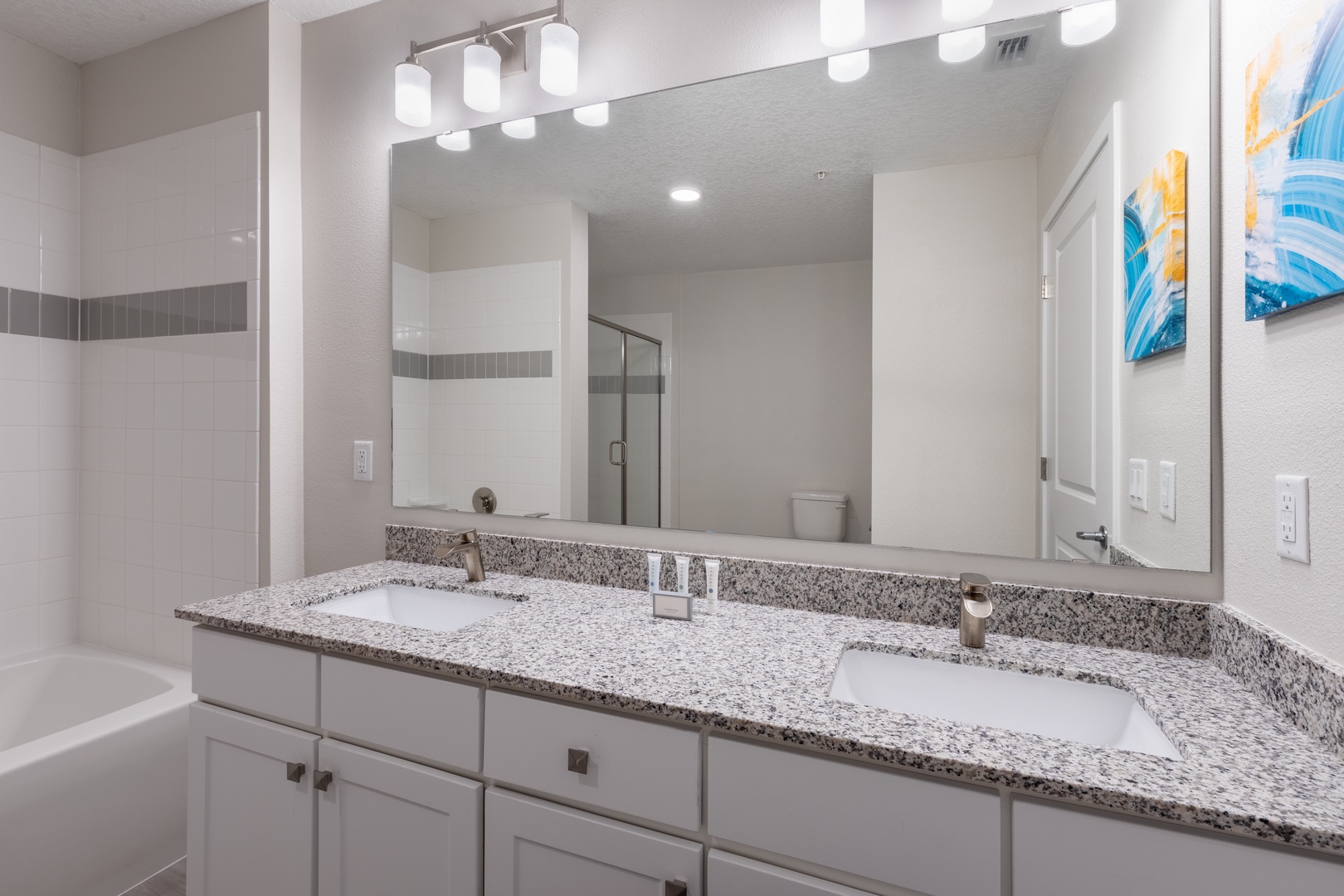 Your spacious dual-sink vanity offers elegant granite counters and bright lighting for your morning routine.