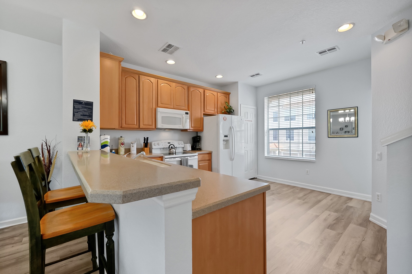 Your spacious kitchen features warm wood cabinets, granite counters, and a breakfast bar where you can enjoy morning coffee.