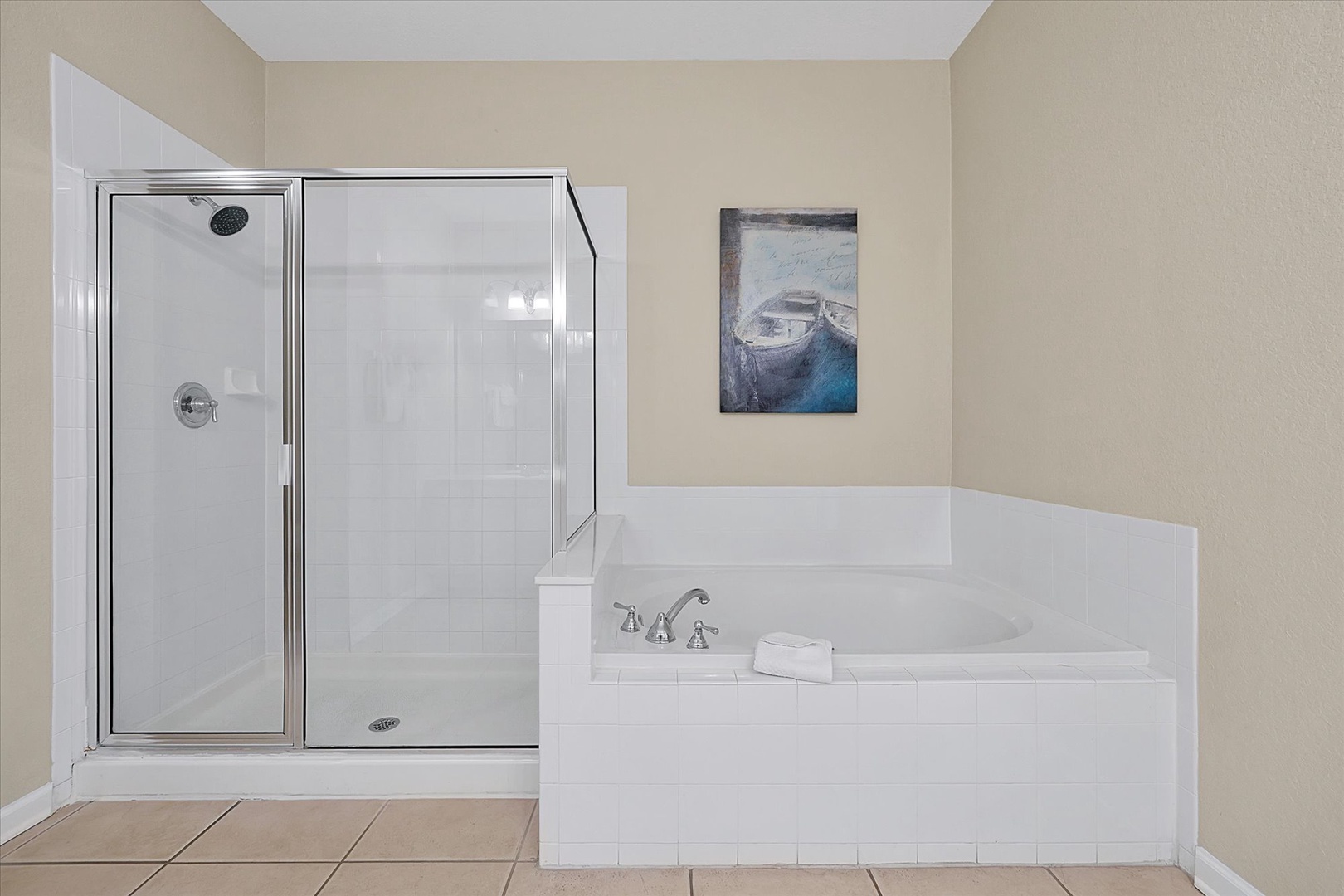 Unwind in your private spa-like bathroom featuring a deep soaking tub and spacious glass shower.