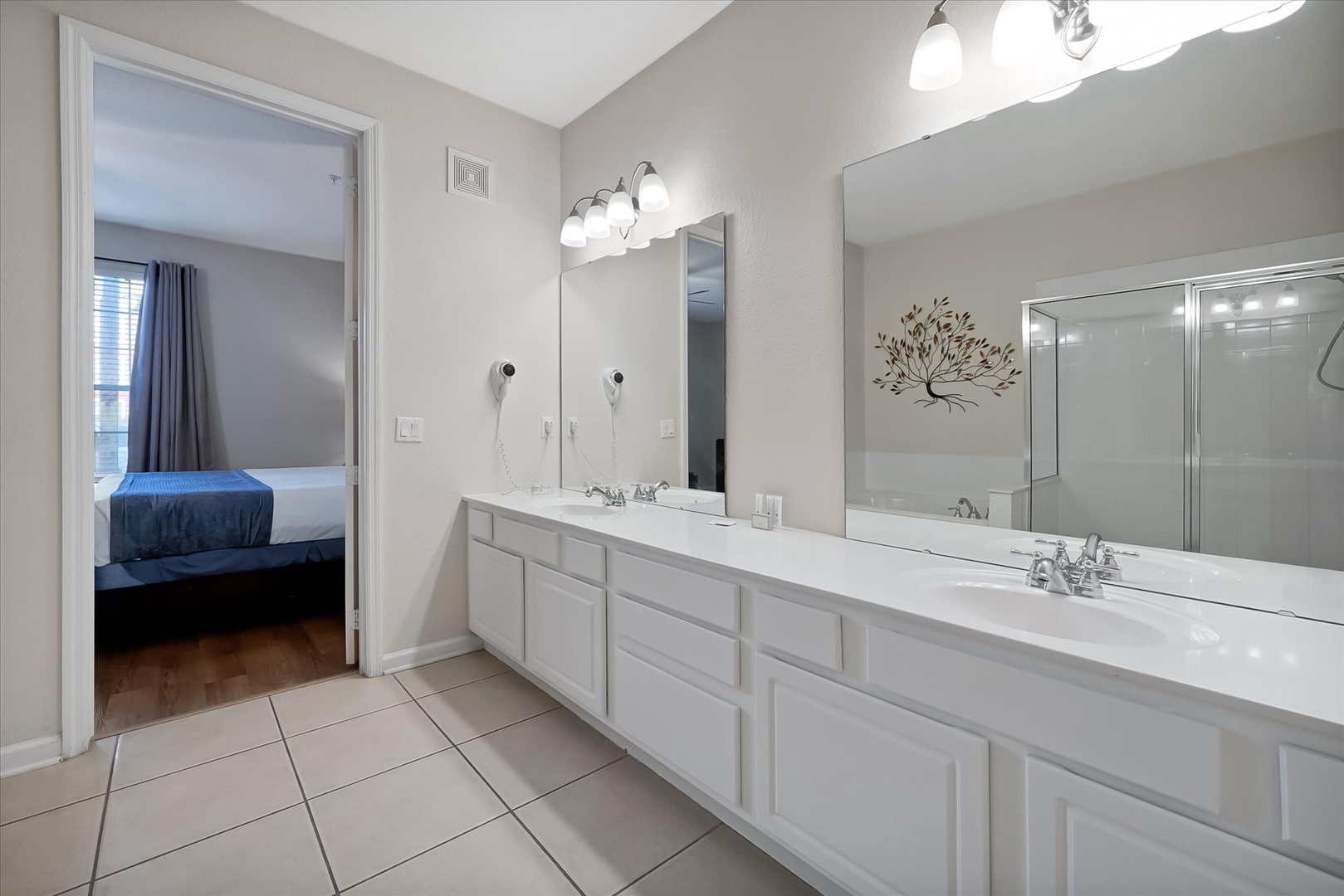 Your spacious master bathroom features dual vanities with bright lighting, perfect for getting ready together each morning.