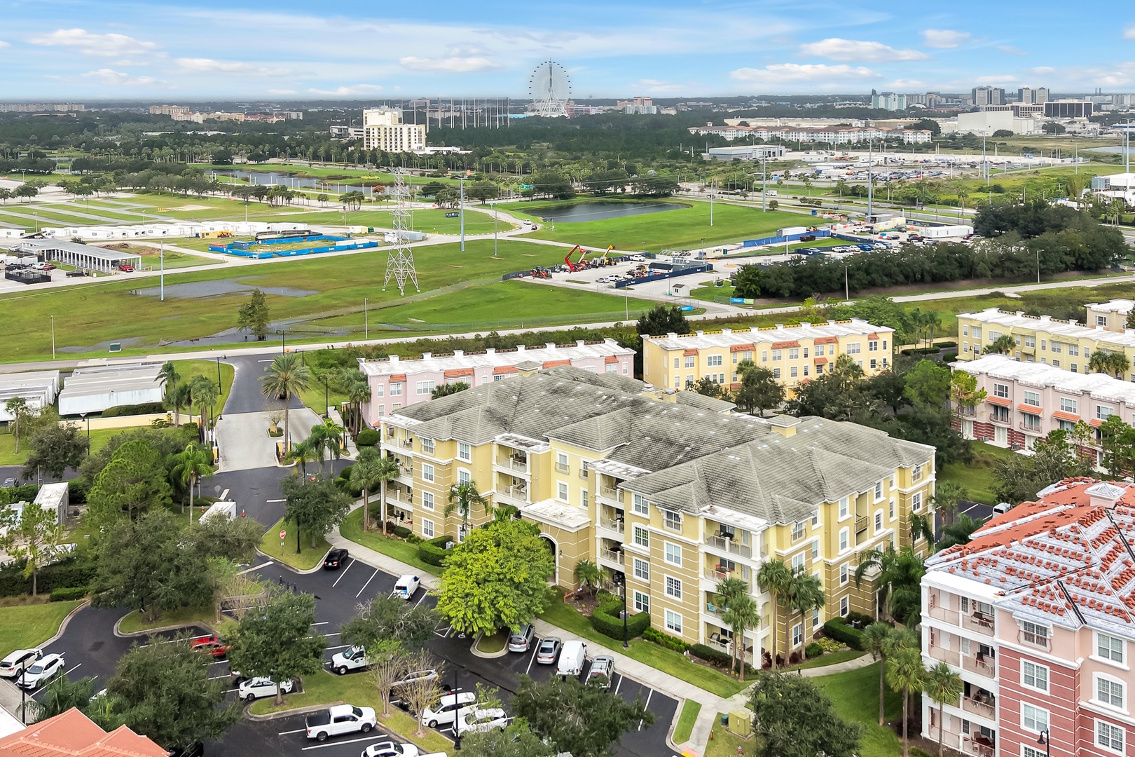 Aerial view of the property and surrounding area, with nearby attractions including parks, pools, and entertainment venues visible in the distance.