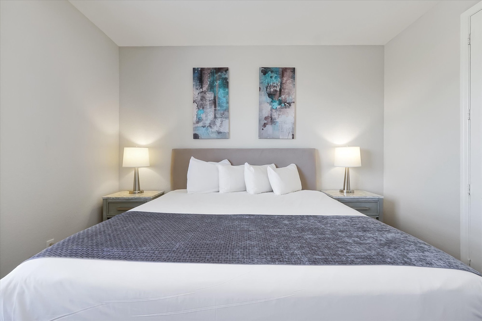 Sink into plush white linens and let the gentle bedside lighting create your perfect evening retreat.