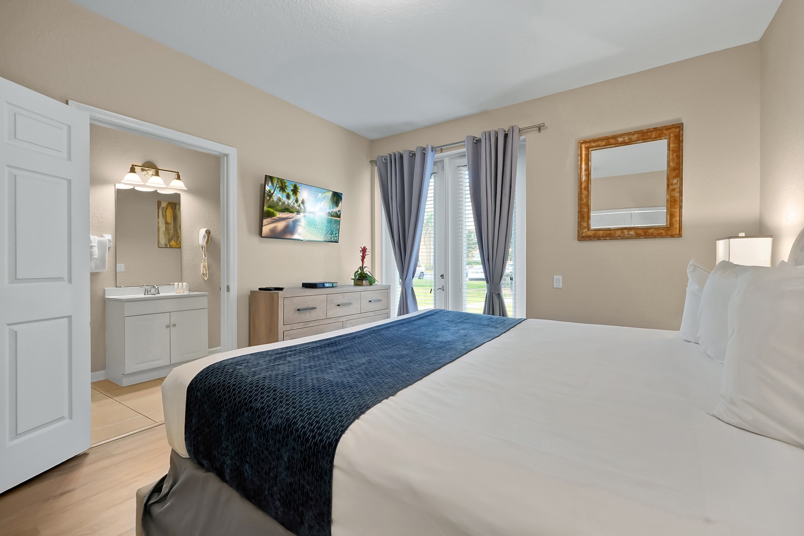Drift into restful sleep on crisp linens while tropical artwork transports you to paradise. Your private bathroom awaits just steps away.