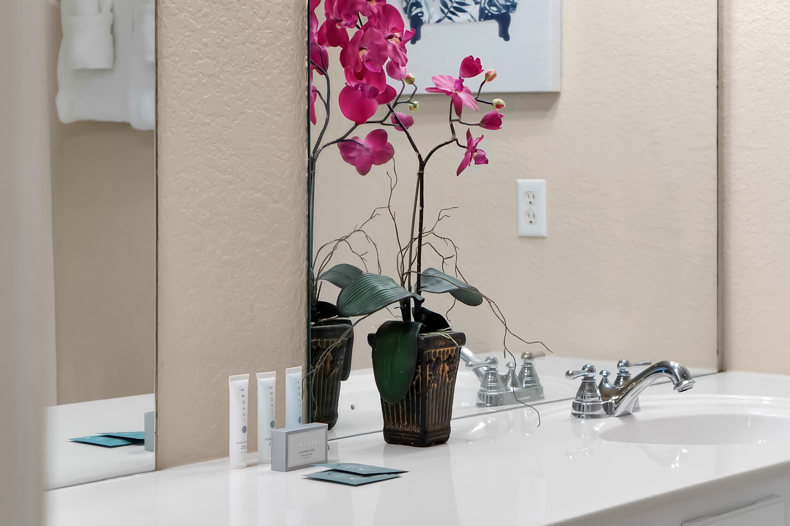 Fresh orchids and premium amenities welcome you to your private spa-like bathroom retreat.