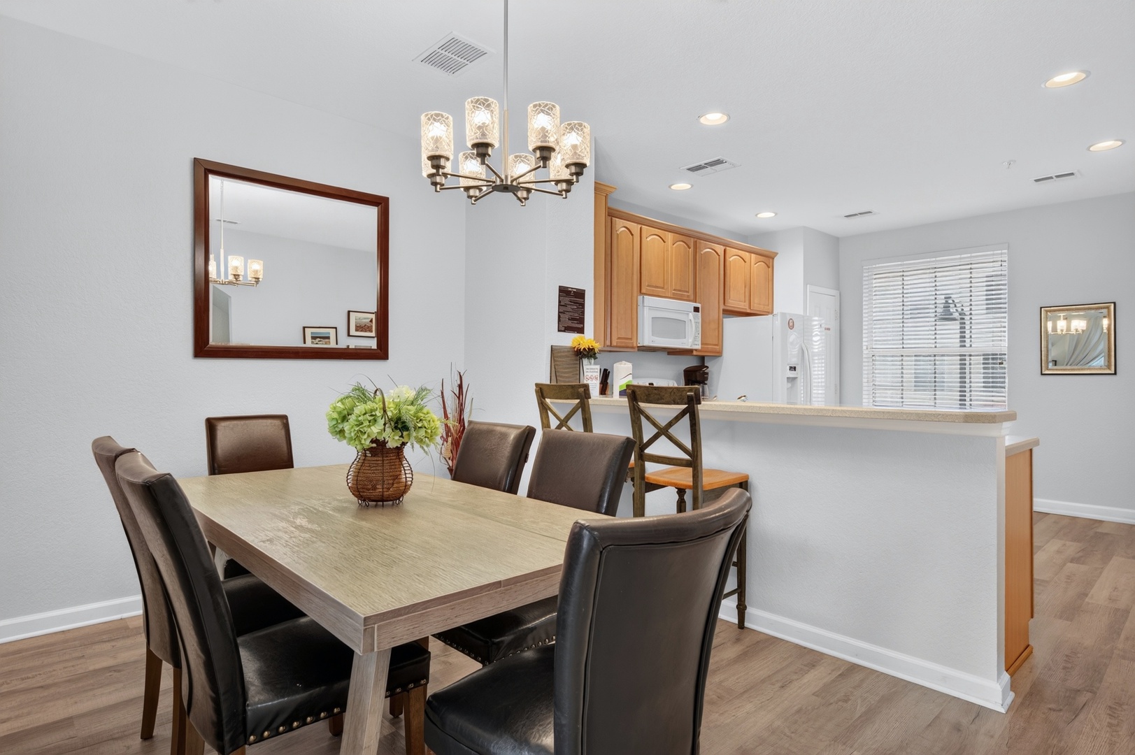 Gather around this welcoming dining space where natural light pours in and thoughtful touches invite memorable meals together. The open layout connects effortlessly to the kitchen, making hosting feel easy and relaxed.