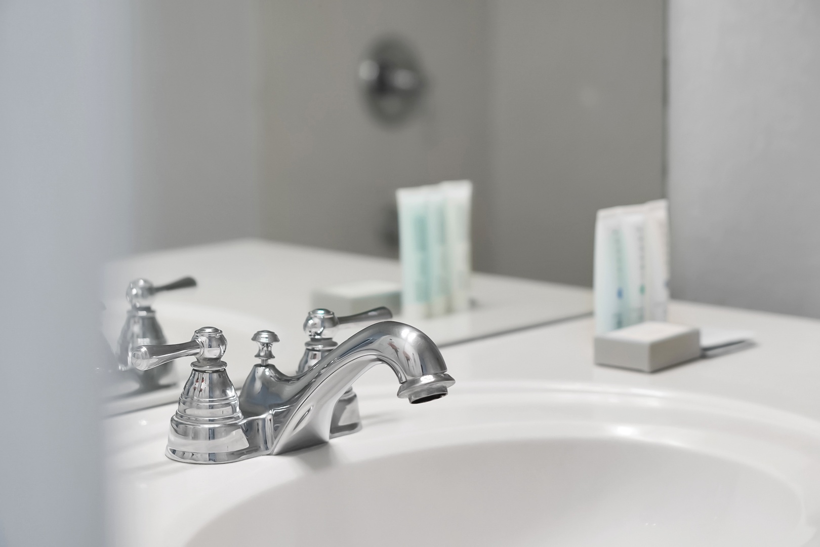 Your pristine bathroom sink features elegant chrome fixtures and complimentary amenities, creating a spa-like atmosphere for your daily routines.