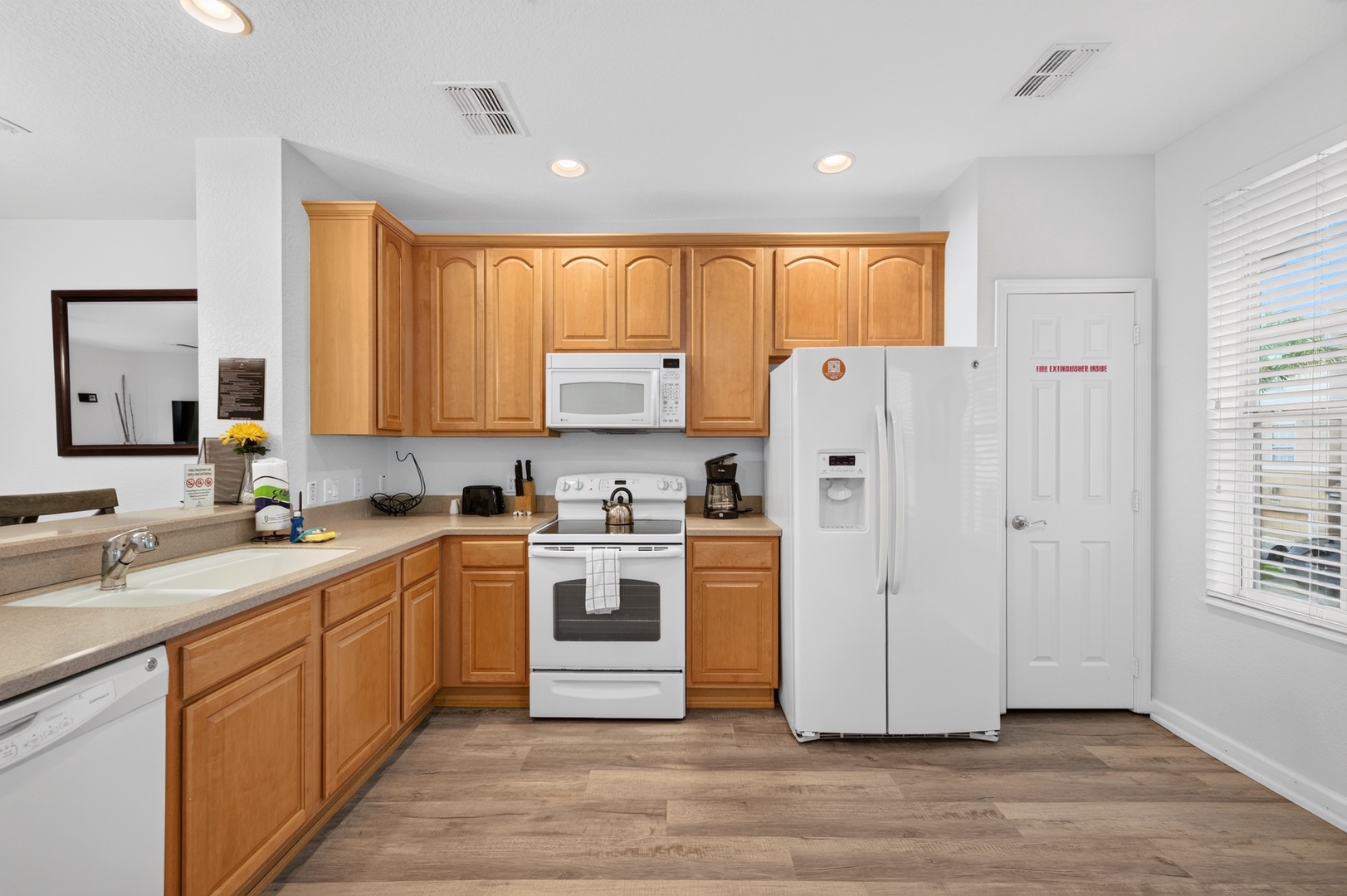 Your fully-equipped kitchen features warm wood cabinetry, modern appliances, and plenty of counter space—perfect for preparing your favorite meals during your stay.