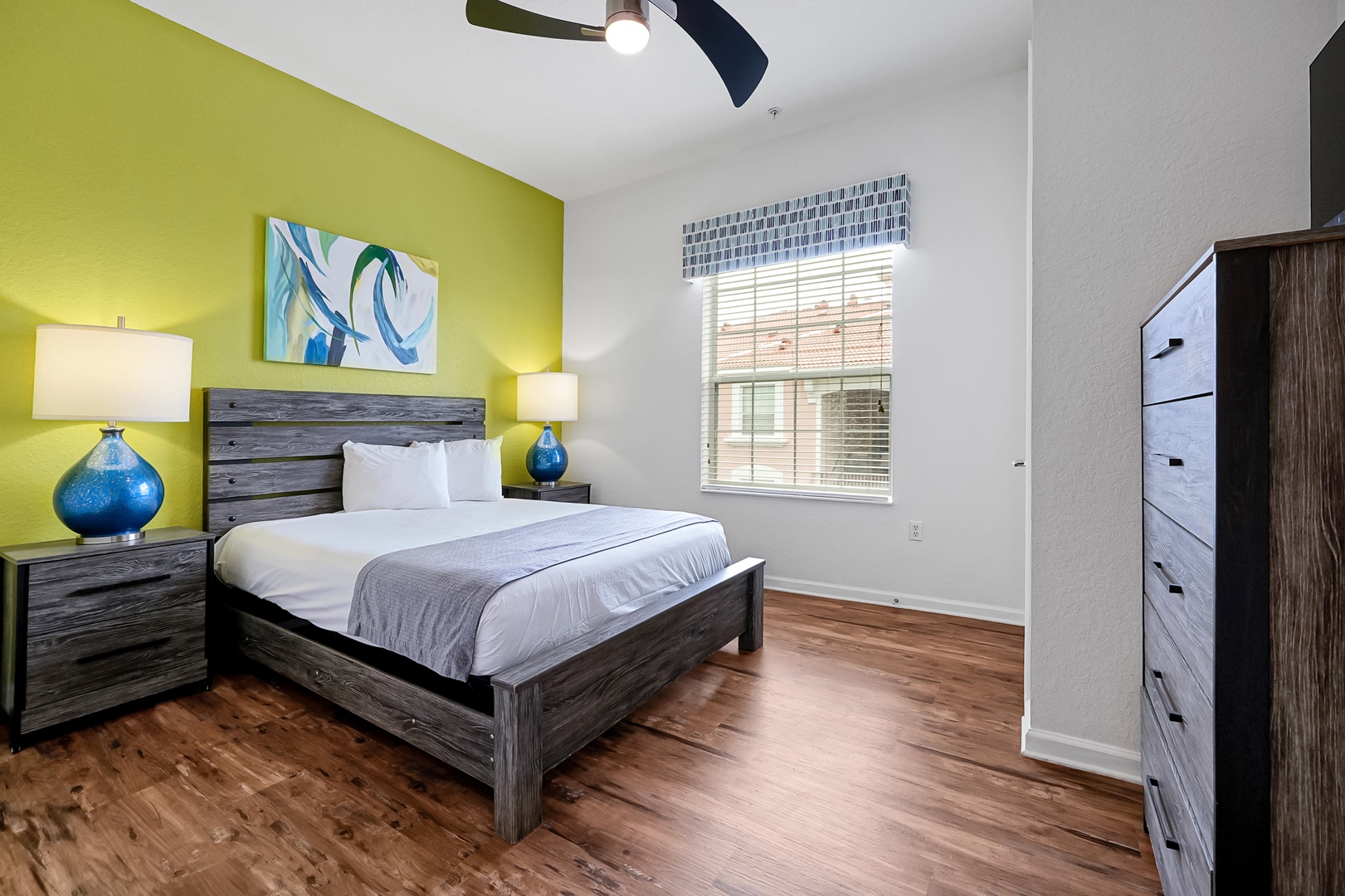 Unwind in your bright bedroom with a cozy bed, stylish furnishings, and warm wood floors that welcome you home after a day of adventure.