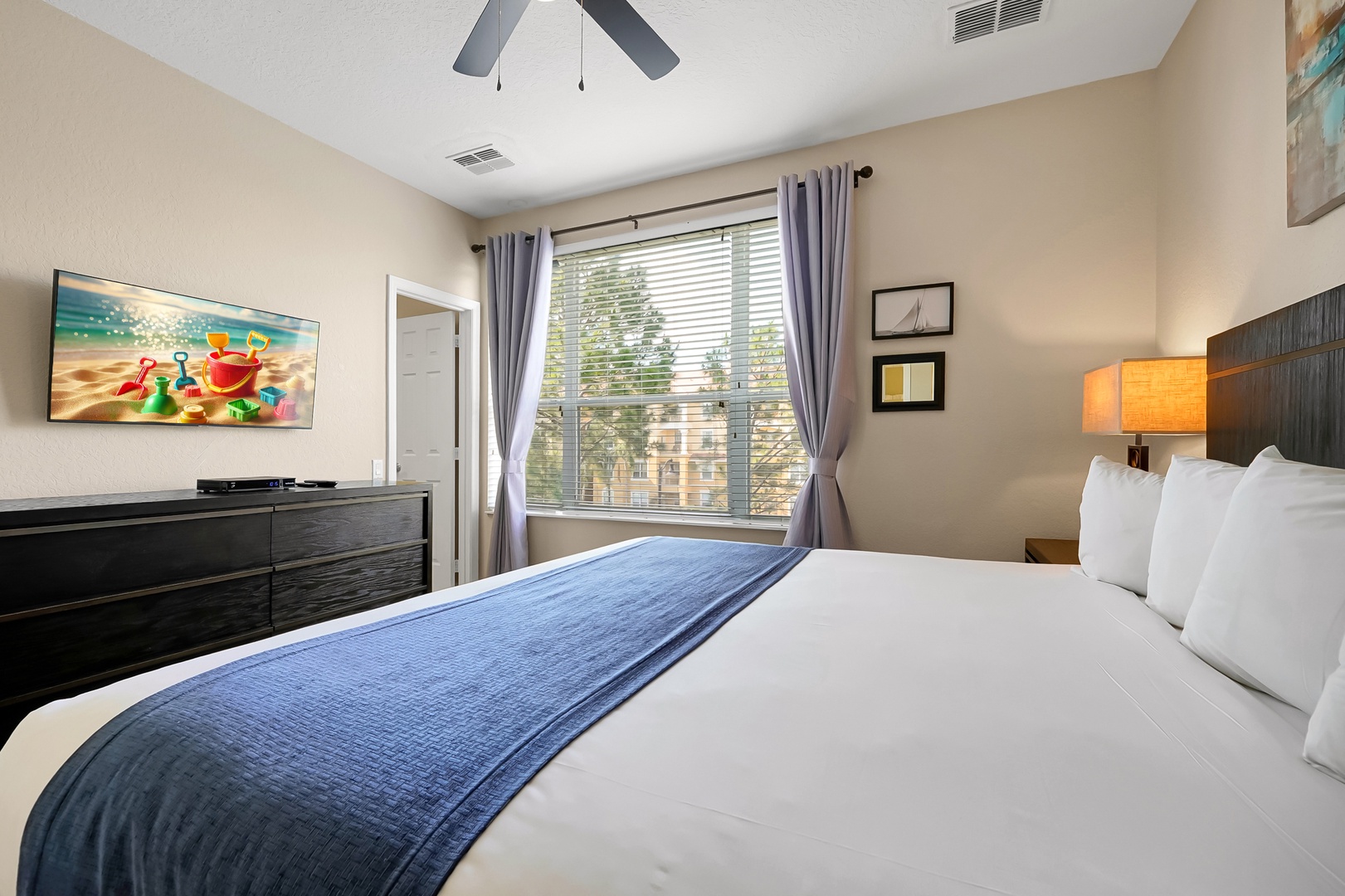 Sink into your plush king bed with crisp linens and watch your favorite shows on the flat-screen TV in this serene bedroom.