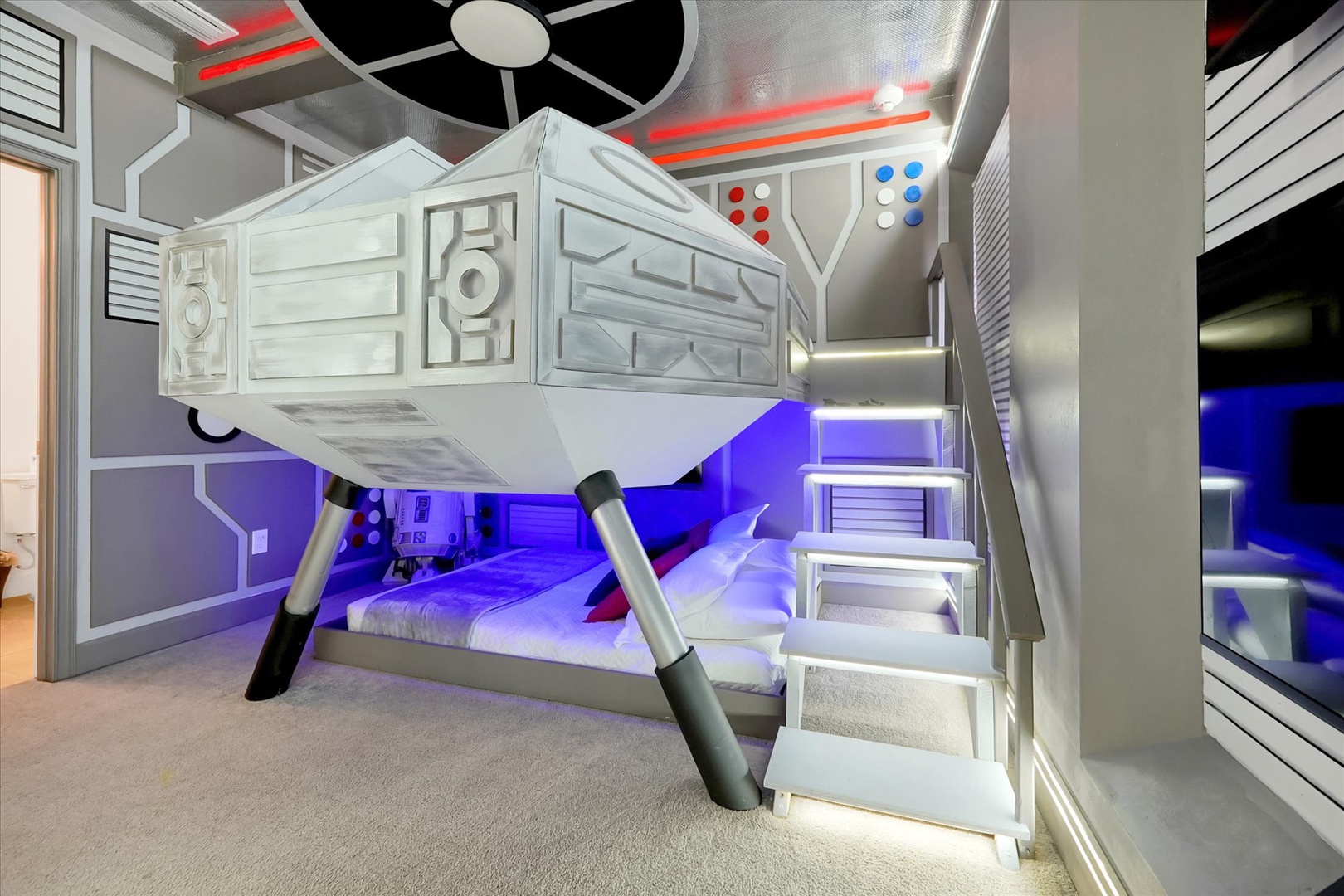 Unleash your imagination in this epic spaceship-themed bunk room with glowing lights, custom details, and out-of-this-world design perfect for young adventurers.