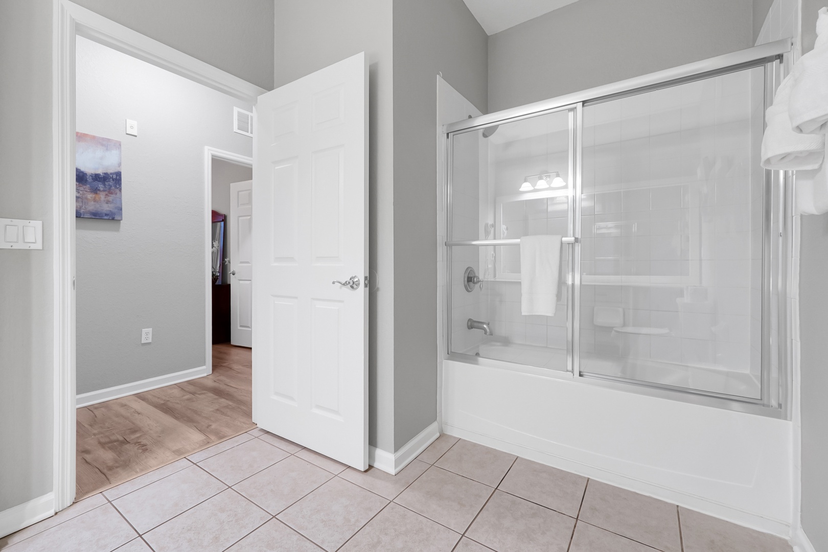 Step into your private bathroom with its bright, clean lines and spacious tub-shower combo. Fresh towels await after a long day.