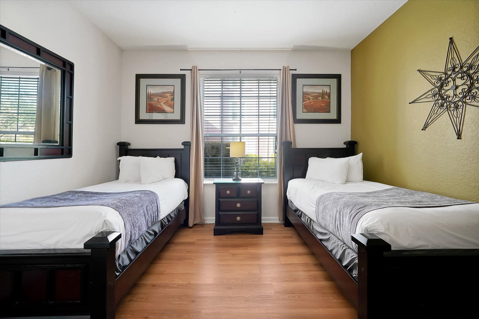 Settle into your peaceful twin bedroom with crisp linens and warm wood floors, perfect for restful nights.
