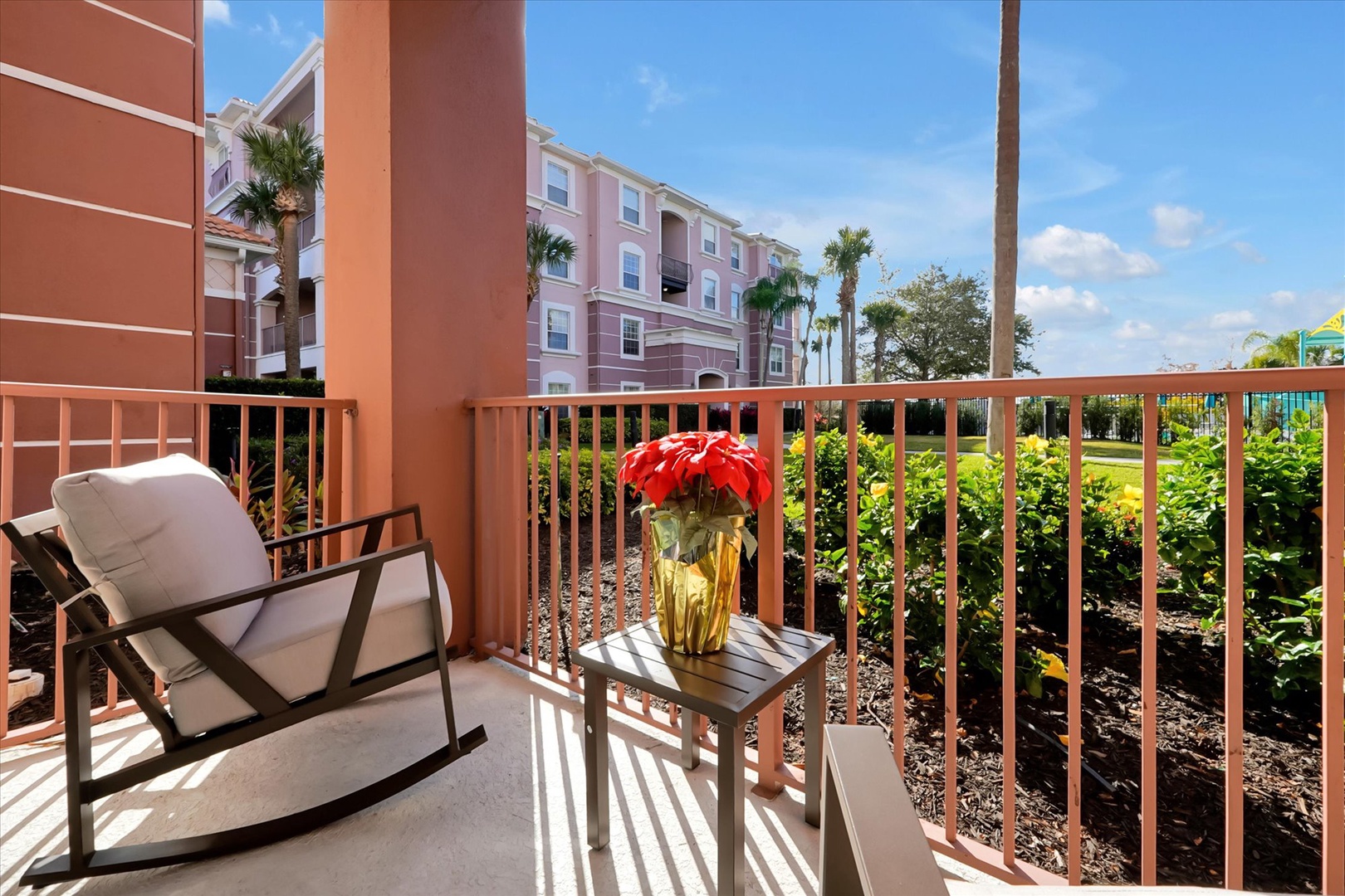 Step onto your private balcony where morning coffee tastes better in the warm Florida sunshine, surrounded by tropical palms and colorful resort views.