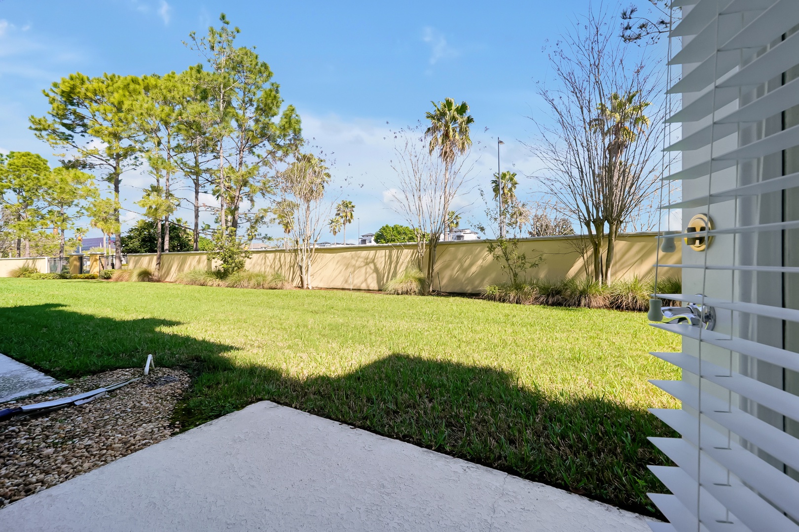Your private backyard oasis features a spacious lawn perfect for morning coffee or evening relaxation.