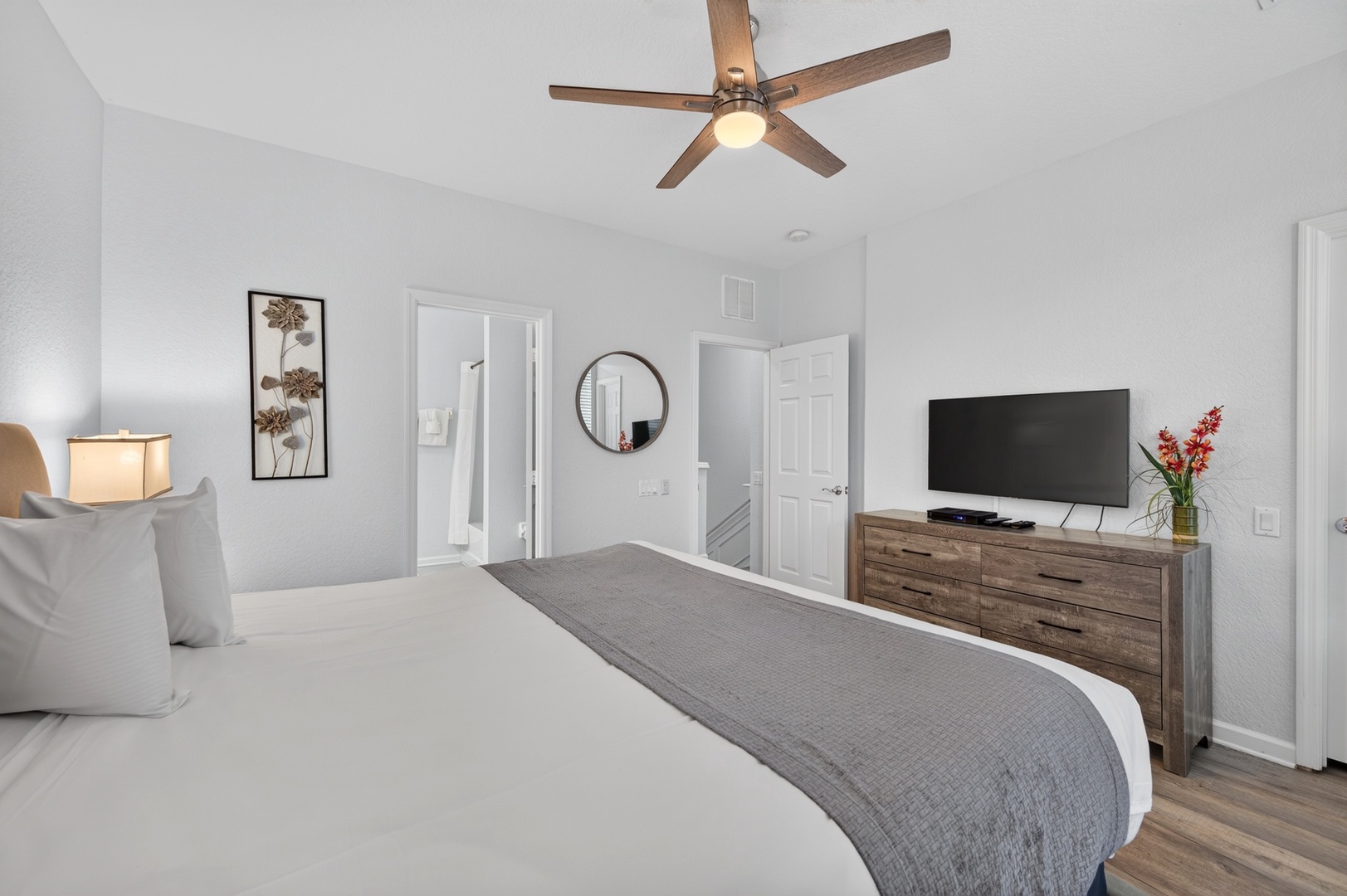 Your serene retreat features a plush bed dressed in crisp linens, warm wood accents, and thoughtful touches like soft lighting and fresh florals to welcome you home after a day of adventure.