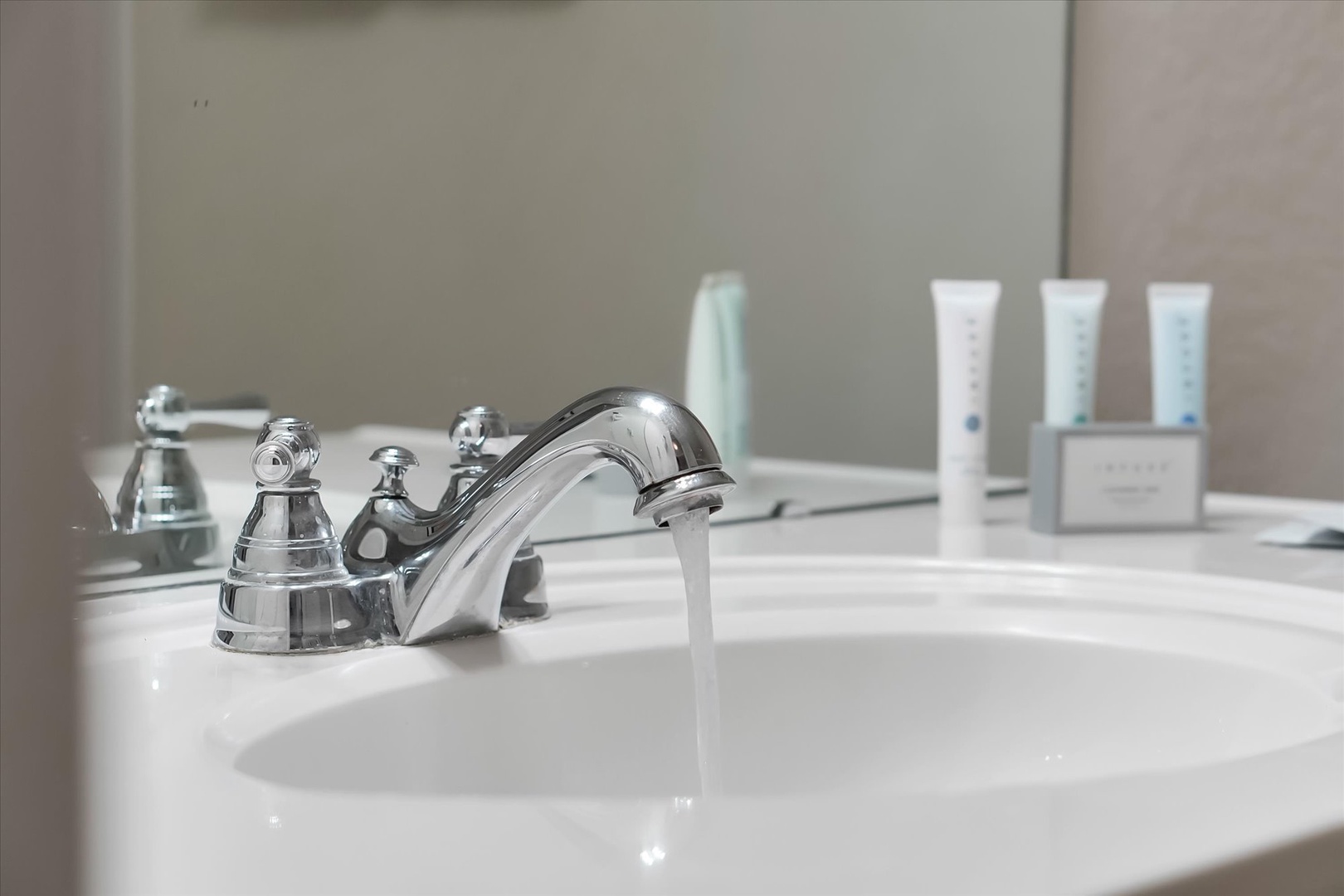 Your private bathroom features a gleaming sink with premium toiletries thoughtfully arranged for your comfort and convenience.