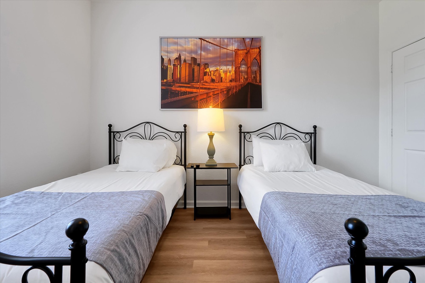 Rest peacefully in your twin bedroom featuring elegant iron-framed beds and crisp linens