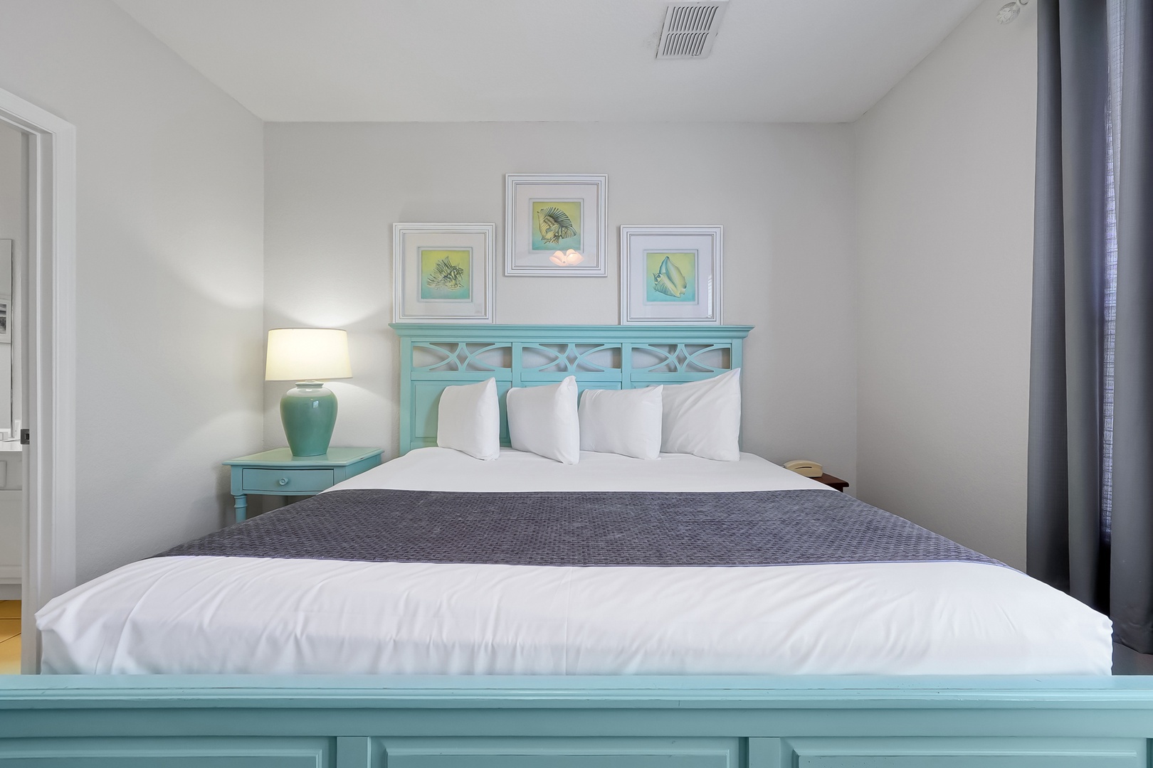 Drift into peaceful sleep surrounded by calming coastal colors and crisp linens in your serene bedroom retreat.
