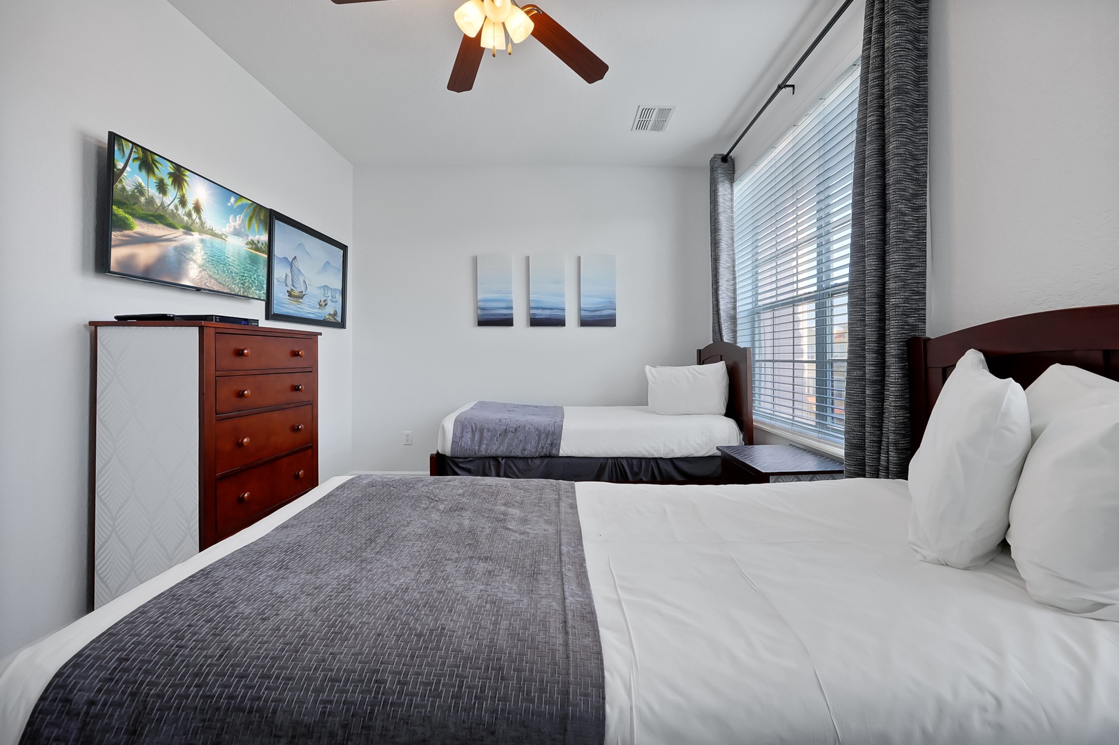 Rest easy in your comfortable twin bedroom with modern amenities, entertainment, and soothing coastal artwork to inspire sweet dreams.