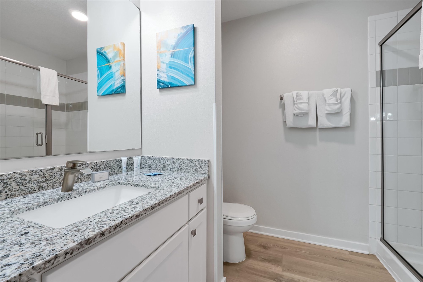 Your modern bathroom features granite countertops, fresh white towels, and a spacious walk-in shower for a refreshing start to each day.