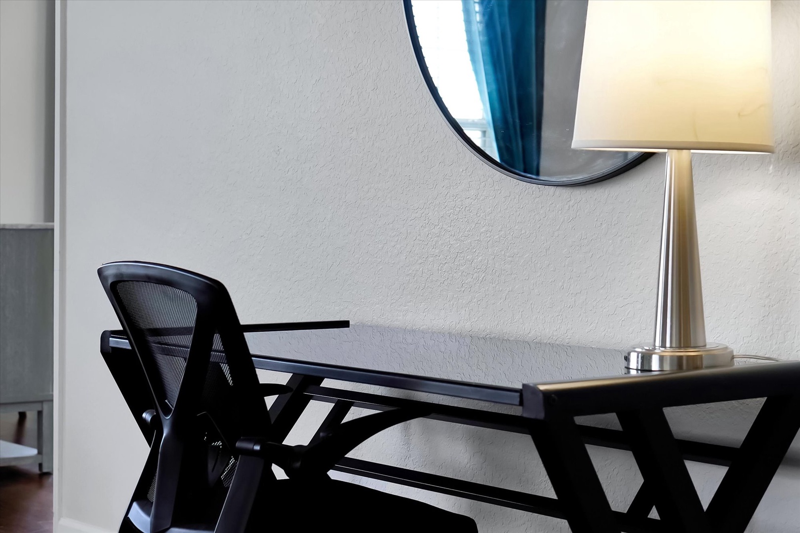 Your dedicated workspace awaits with an ergonomic chair, sleek desk, and warm lighting for productive remote work sessions.