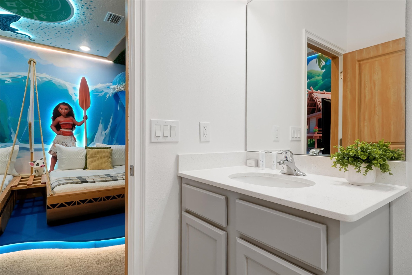 Step into your private ensuite with a clean vanity and mirror, connecting to a beautifully themed bedroom just beyond the door.