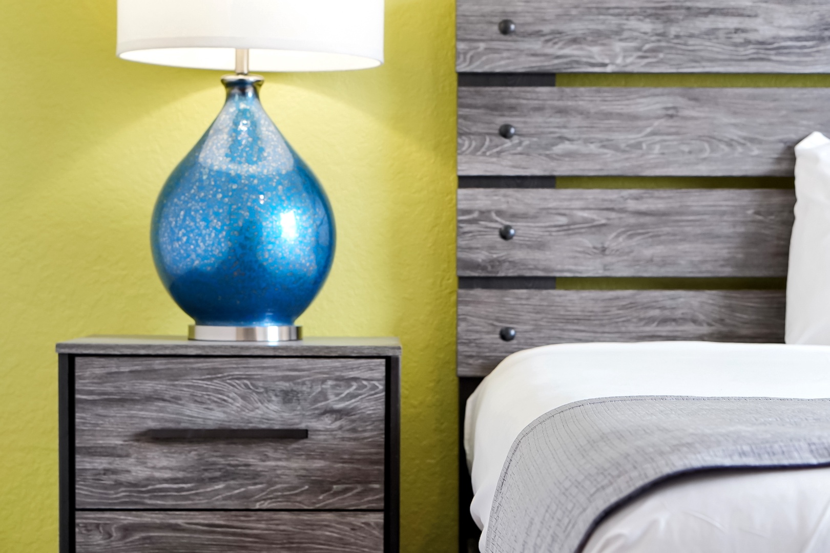 Rest easy in your modern bedroom with bright pops of color and contemporary furnishings designed for your comfort.