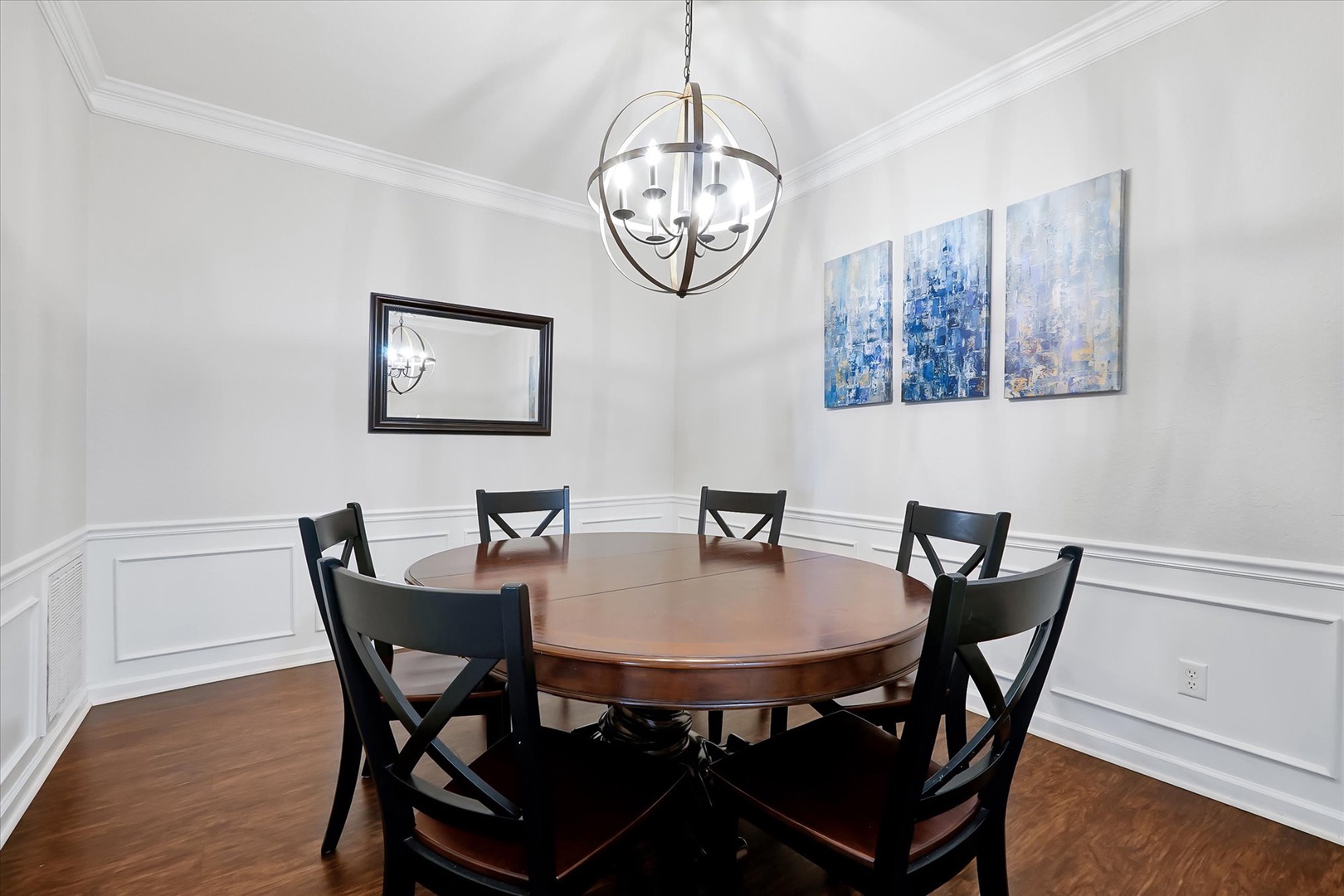 Gather around this elegant dining table where your group can enjoy memorable meals together beneath the stunning chandelier.