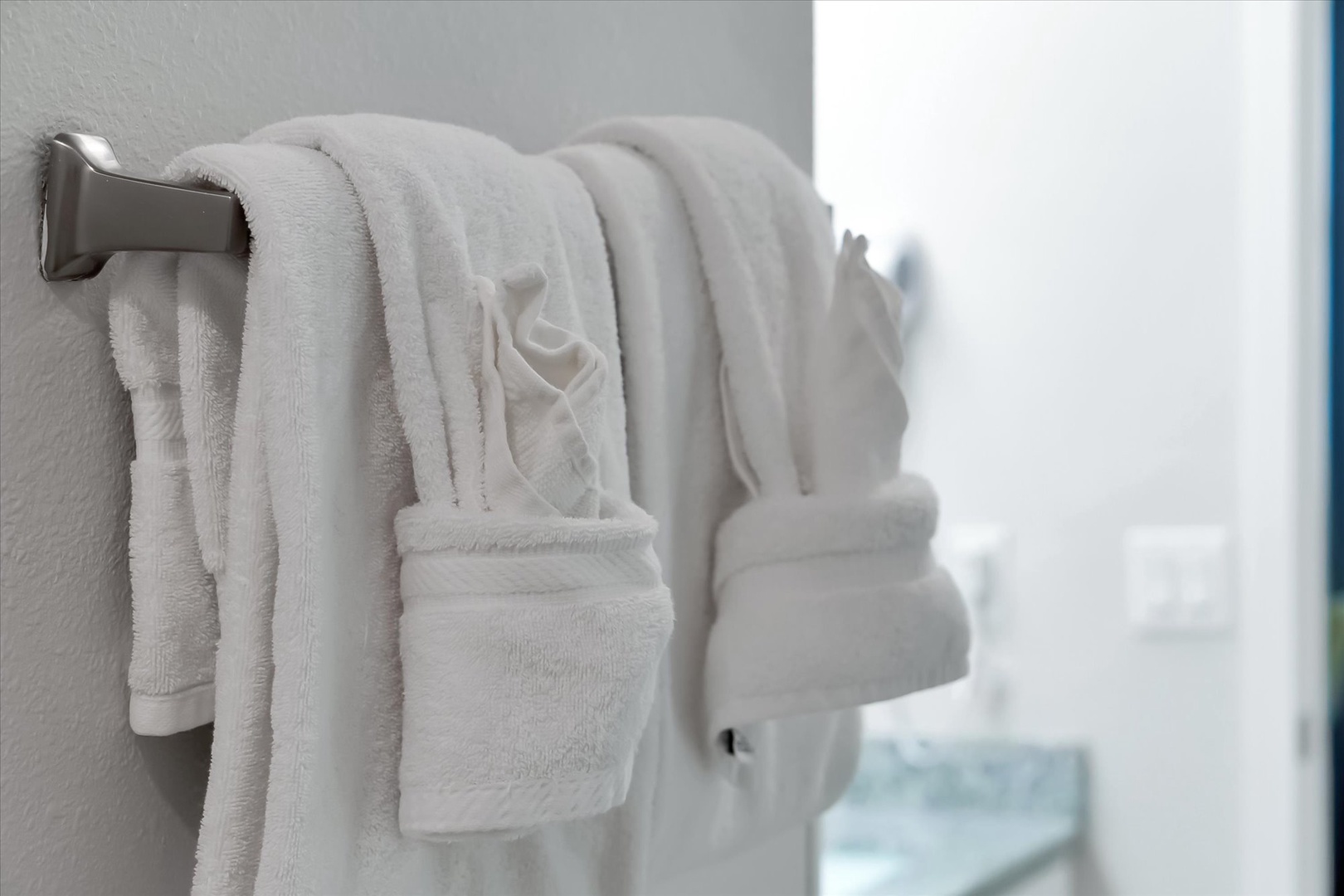Luxurious white bathrobes wait for you to slip into after your morning shower, promising spa-like comfort.