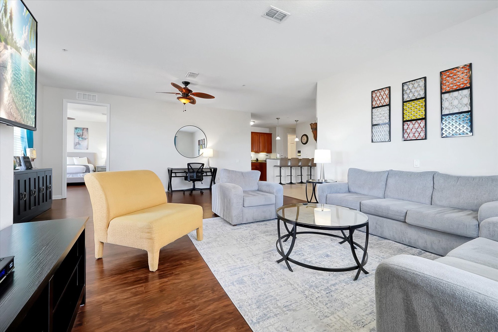 Settle into your stylish open-concept living space with plush seating, modern decor, and seamless flow to the kitchen.