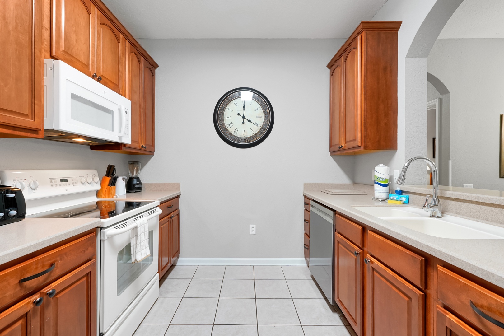 Your fully equipped kitchen features warm wood cabinetry, ample counter space, and modern appliances—perfect for preparing family meals or morning coffee during your stay.