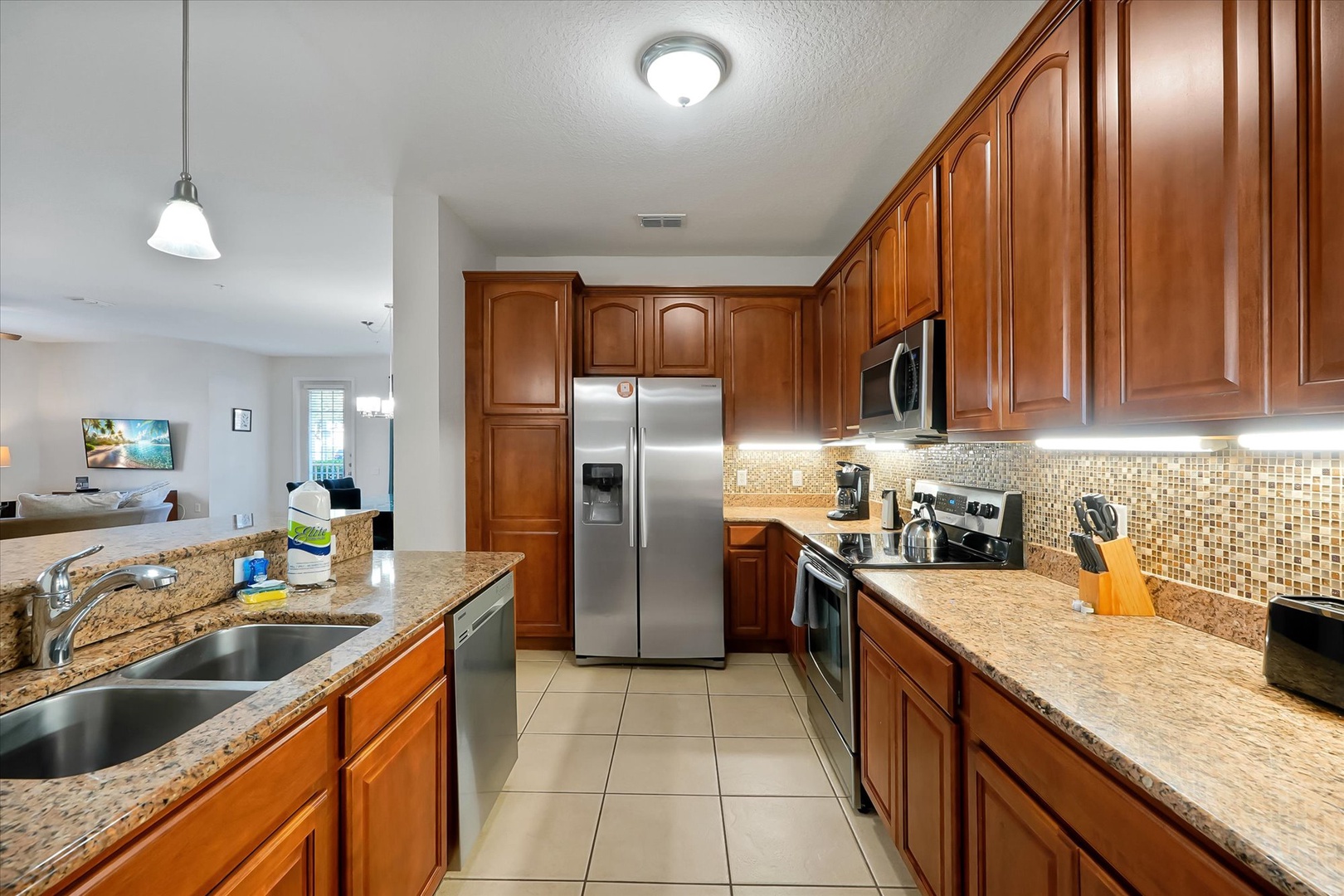 Your spacious kitchen features rich wood cabinets, granite counters, and modern appliances perfect for preparing memorable meals together.