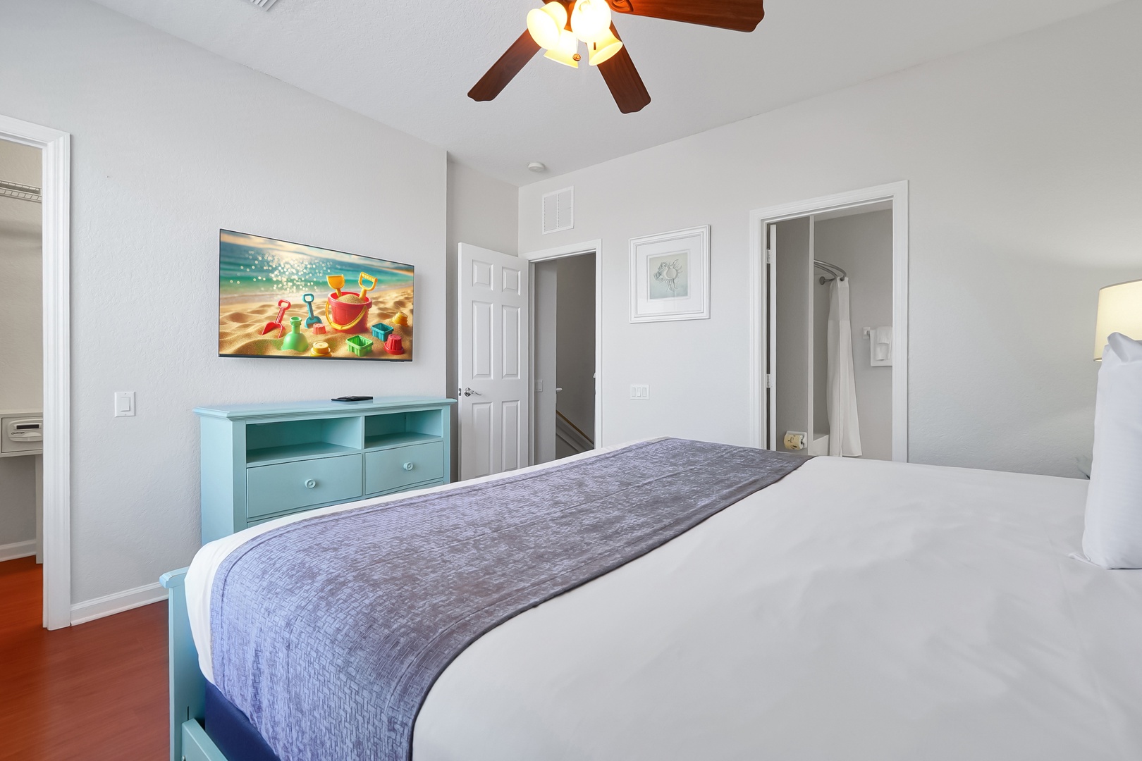 Unwind in your bright, cheerful bedroom with crisp linens and beach-themed art setting the perfect coastal mood for your getaway.