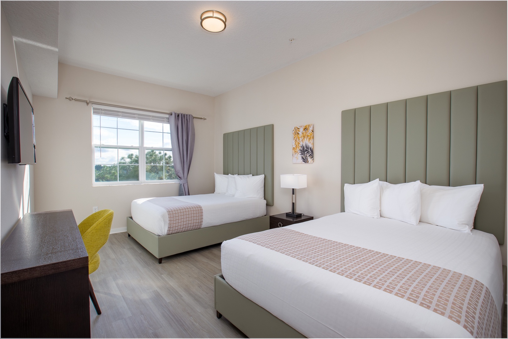 Rest comfortably in your stylish twin bedroom with modern amenities and crisp linens for a perfect night's sleep.