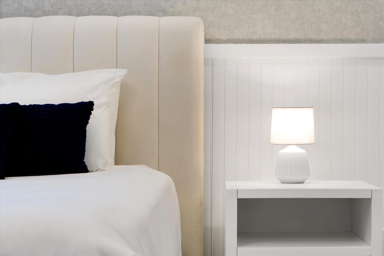 Sink into plush bedding and enjoy the soft glow of your bedside lamp—your peaceful retreat awaits after a day of exploring.